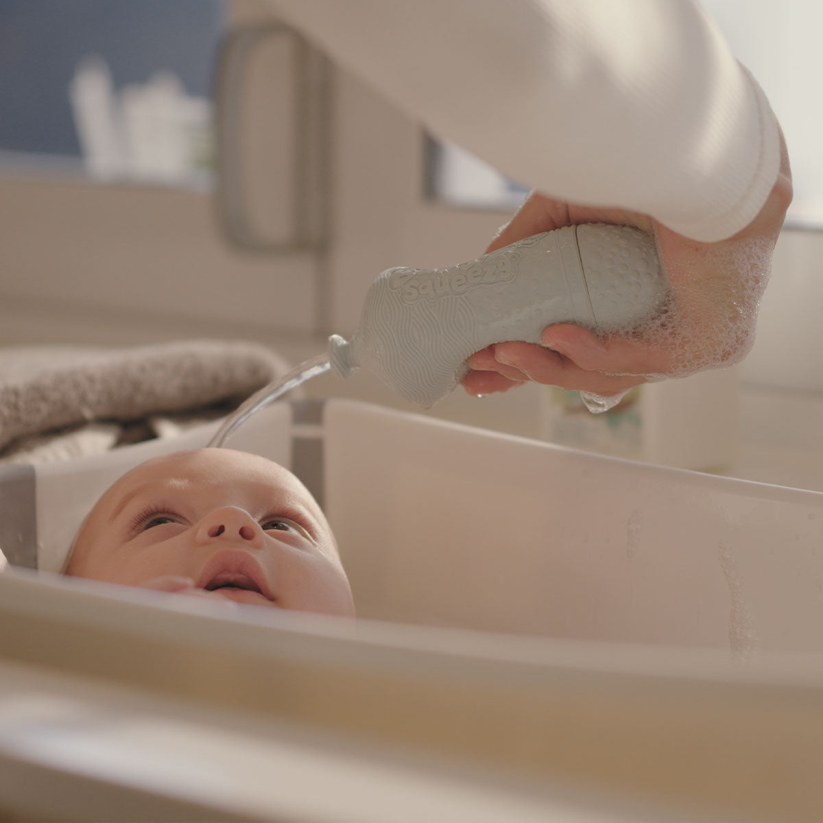 BabySqueezy is a 3-in-1: Newborn Bath Rinser, Teether & Toy