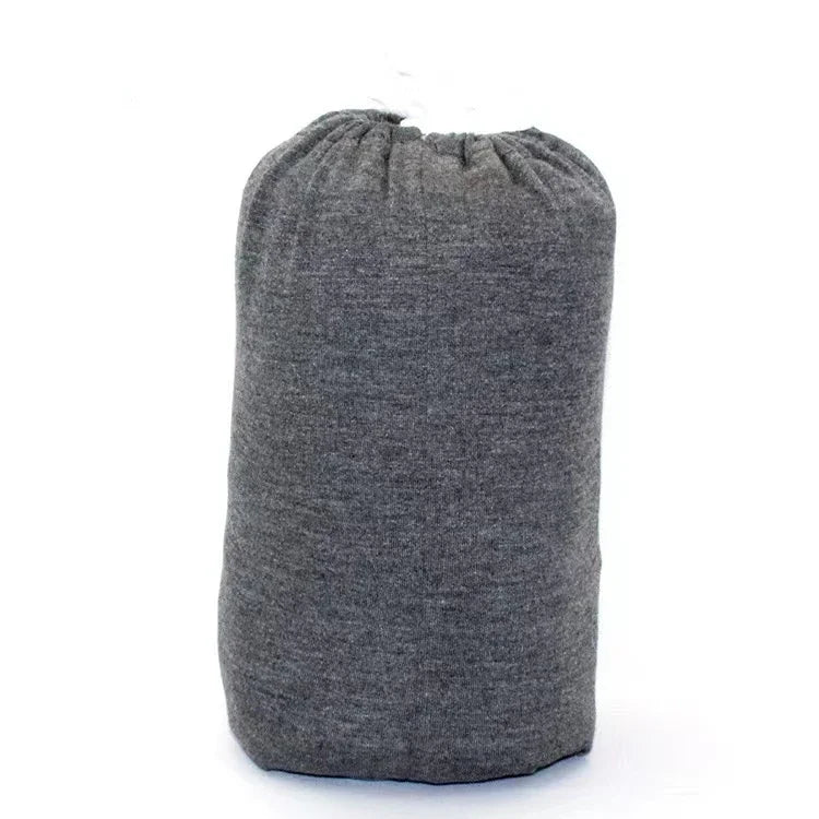 A baby sling wrap carrier with a sleeping infant inside, worn by an adult with one hand supporting the baby's head.