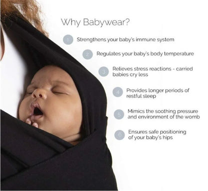 A baby sling wrap carrier with a sleeping infant inside, worn by an adult with one hand supporting the baby's head.