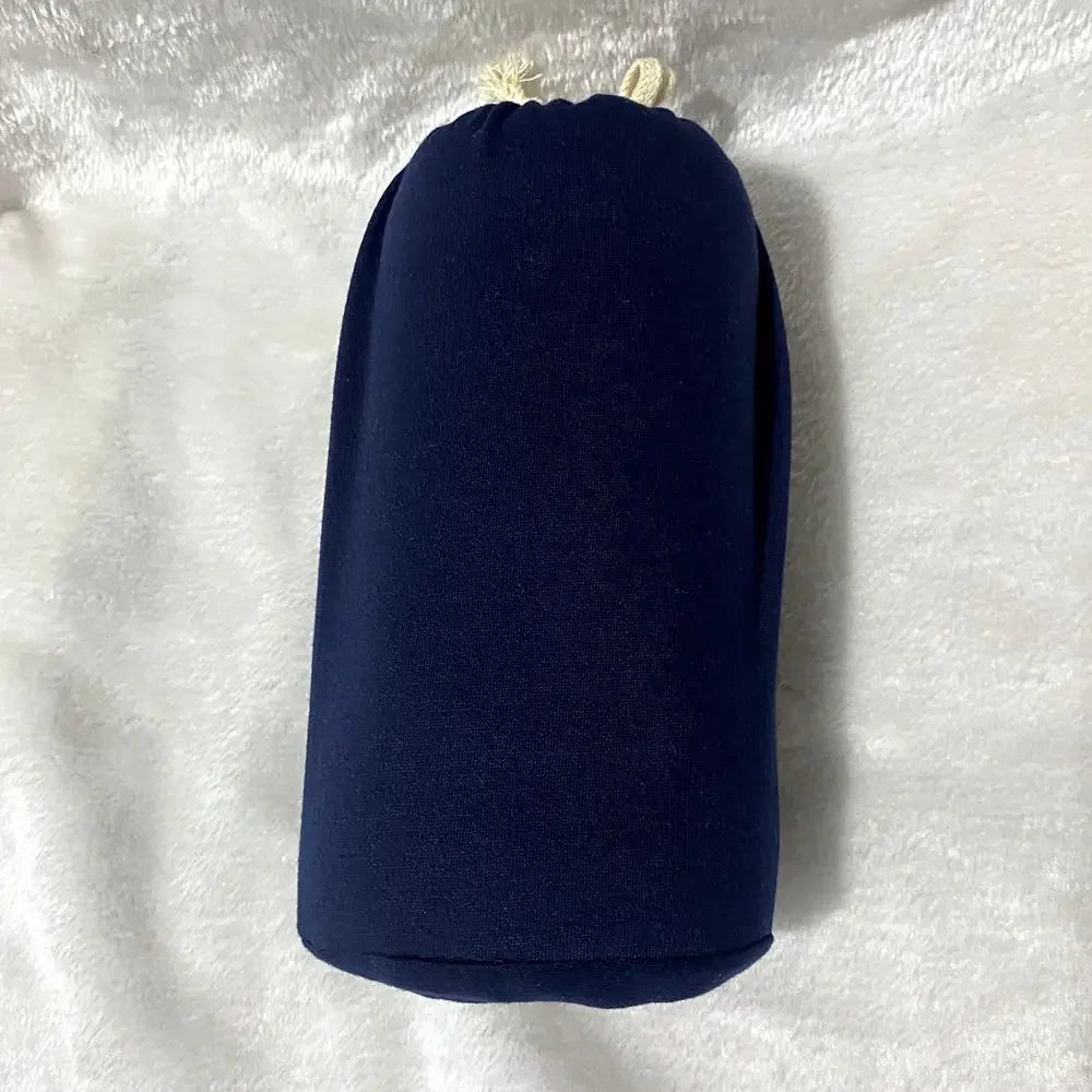 A baby sling wrap carrier with a sleeping infant inside, worn by an adult with one hand supporting the baby's head.