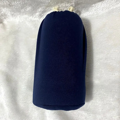 A baby sling wrap carrier with a sleeping infant inside, worn by an adult with one hand supporting the baby's head.