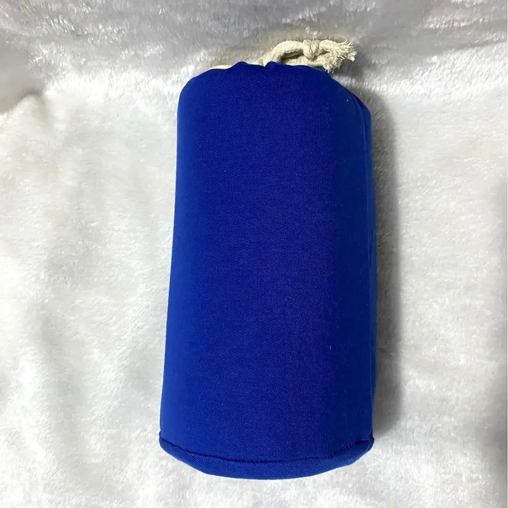 A baby sling wrap carrier with a sleeping infant inside, worn by an adult with one hand supporting the baby's head.