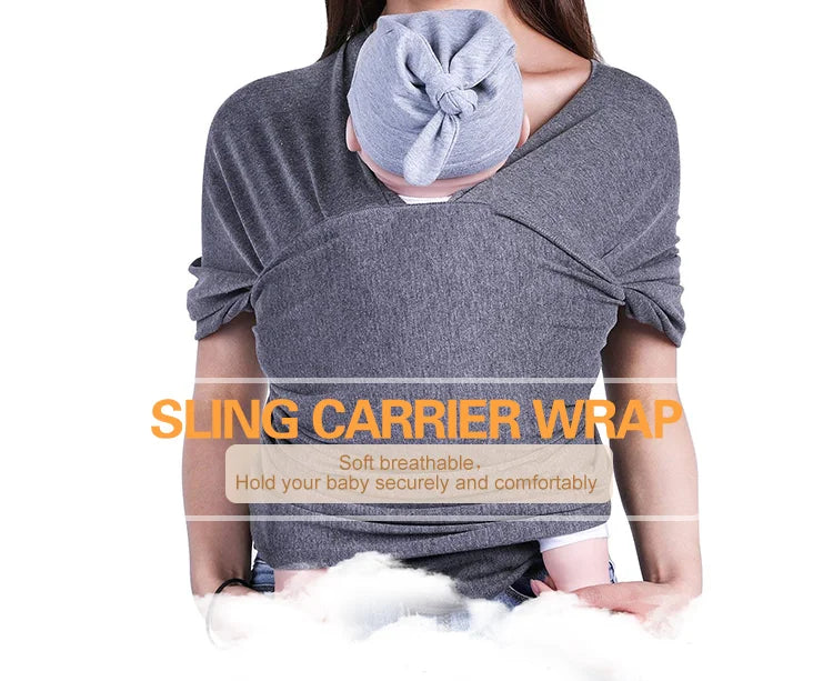 A baby sling wrap carrier with a sleeping infant inside, worn by an adult with one hand supporting the baby's head.