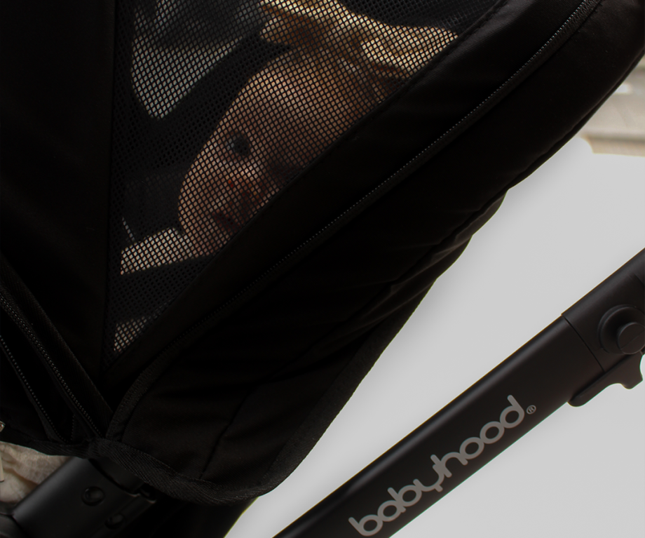 close up image of Babyhood Doppio Plus stroller and baby with bassinet, perfect for infants on a smooth walk.