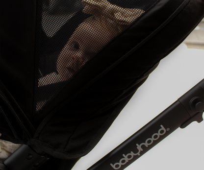 close up image of Babyhood Doppio Plus stroller and baby with bassinet, perfect for infants on a smooth walk.
