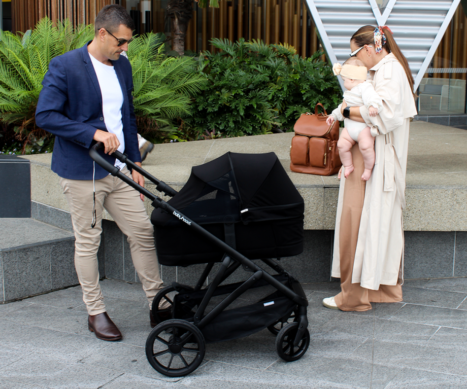 Lifestyle image of Babyhood Doppio Plus stroller with bassinet, perfect for infants on a smooth walk