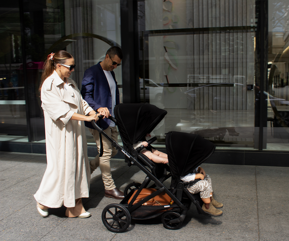 Travel image of Babyhood Doppio Plus stroller with bassinet, perfect for infants on a smooth walk