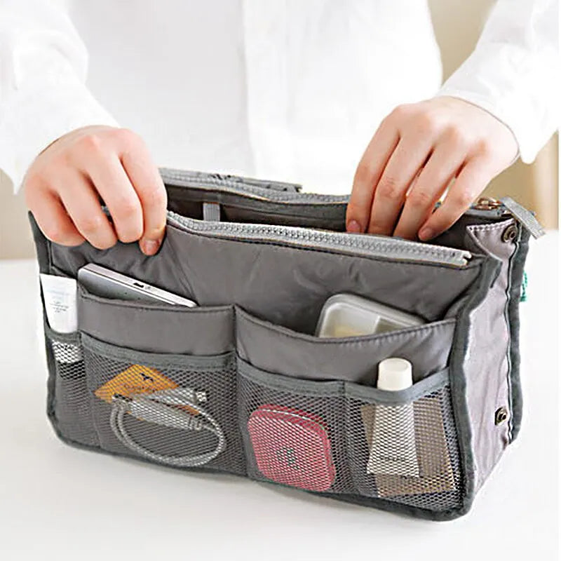 compact bag organiser insert with various compartments, can contain cosmetics, hair items, perfume, creams, keys, electronic devices, all handbag necessities