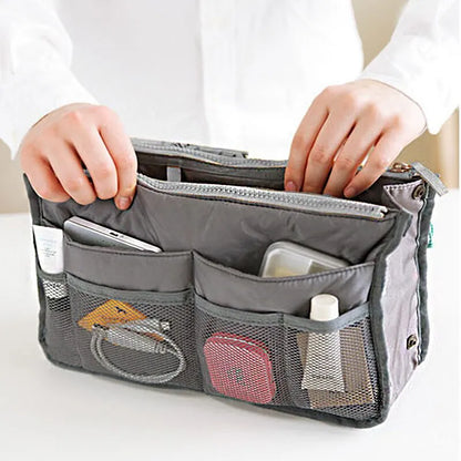 compact bag organiser insert with various compartments, can contain cosmetics, hair items, perfume, creams, keys, electronic devices, all handbag necessities