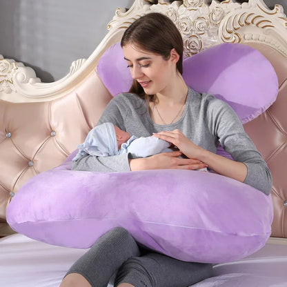 A pregnant woman lying on a purple pregnancy bump support pillow with a solid pattern.